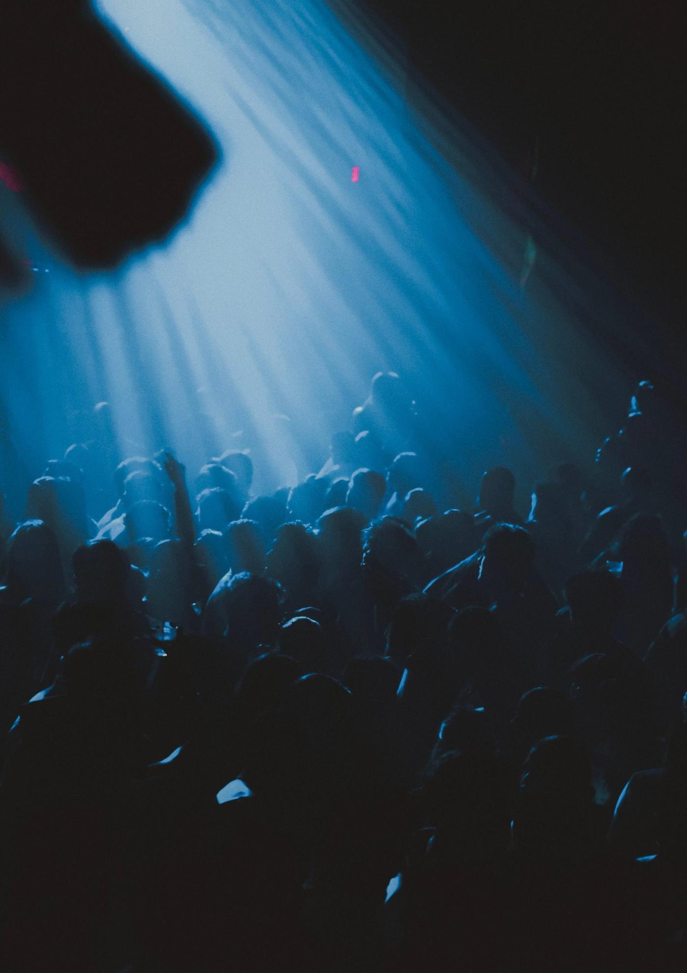 Crowd under blue stage lights