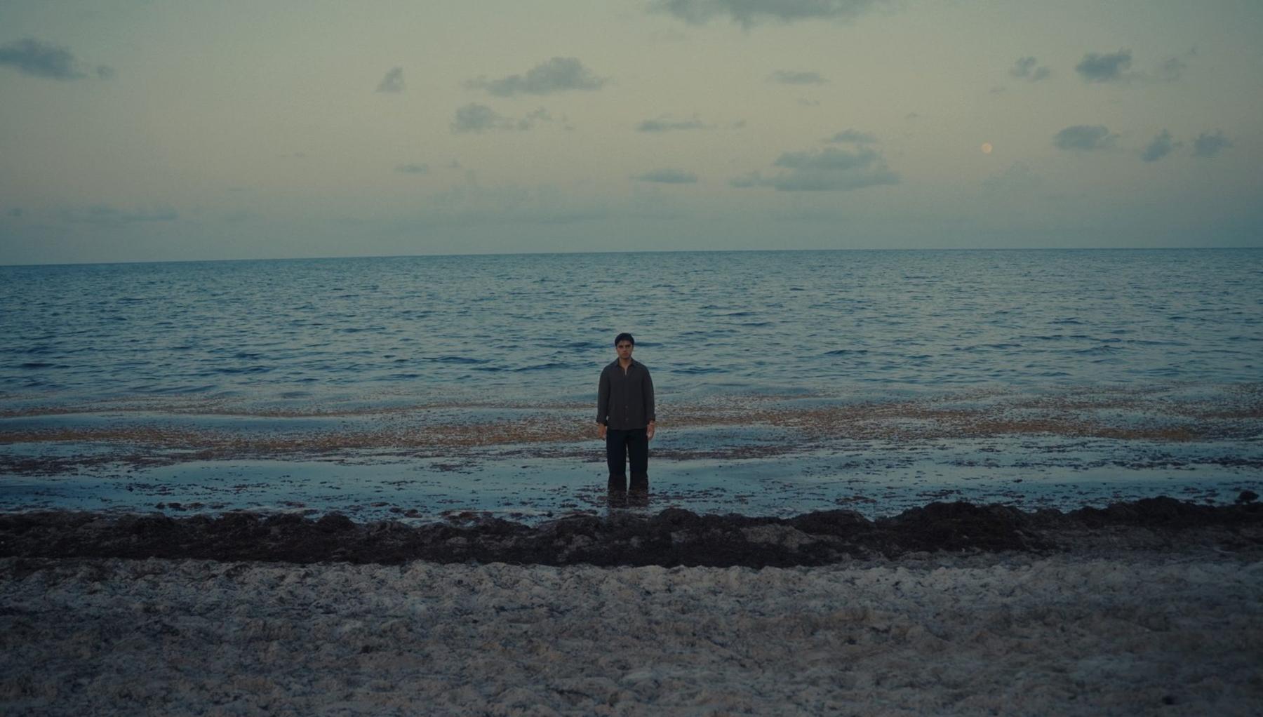 Harry Molina standing in the sea at dusk